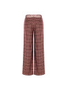 Patchwork-style palazzo trousers with a logoed Rinascimento scarf at the waist